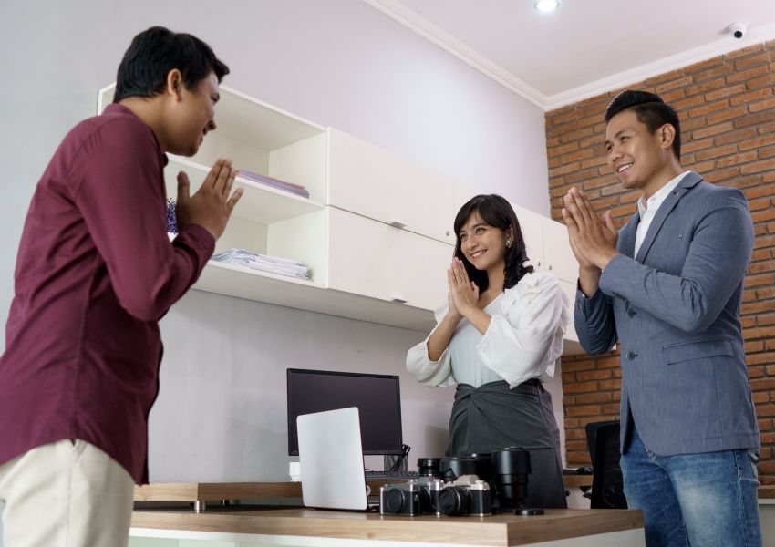two-people-praying-to-another-around-table