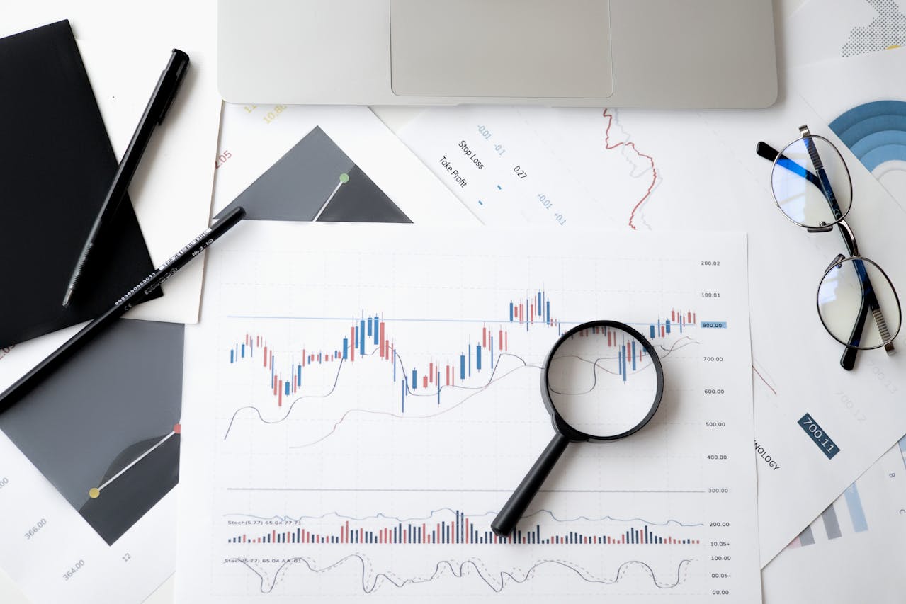 graphs-on-paper-with-magnifying-glass-over-top
