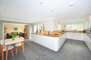 a kitchen with a long counter and tiled floor