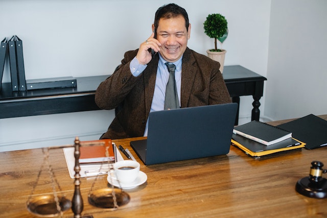 Lawyer sitting at a desk and making a phone call